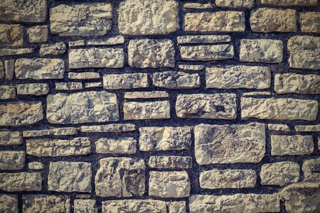 the abstract textured background of a stone wall closeup and a blank space for the textの写真素材