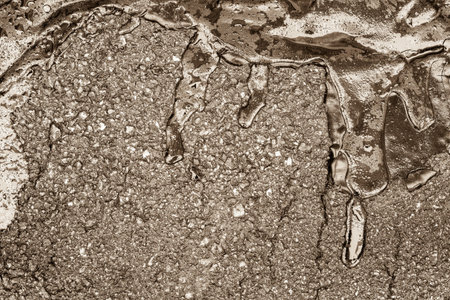 wet glossy brilliant bitumen of an abstract form with water drops on damp asphalt for the textured...