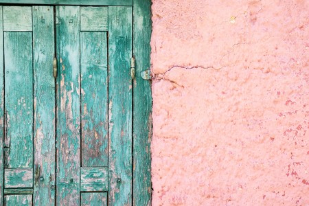 part or fragment of a wall and door of the old house in vintage style for the textured abstract architectural background and for wallpaperの写真素材