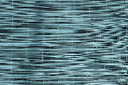 textured a curtain or a screen from a dry reed or straw for an abstract background and for wallpaper...