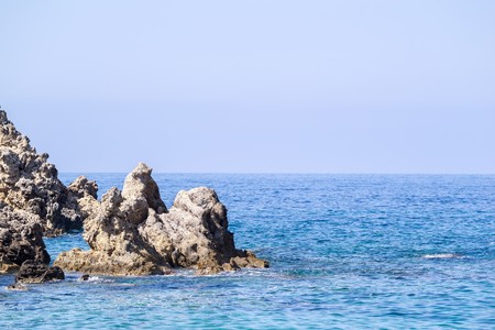 wild colourful landscape of rocky islands at the sea with the line of the horizon and a blank space for the textの写真素材