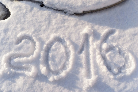 date or figure 2016 are written on brilliant snow by a closeup for Christmas or the New Year's...