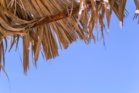 fragment of a solar canopy or umbrella from an old bast against the blue skyの写真素材