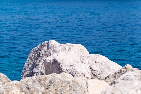 big stones boulders against the blue seaの写真素材