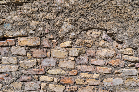 old bumpy abstract texture of the destroyed stone and brick wall for vintage backgrounds and for a retro of wallpaperの写真素材