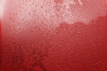 abstract texture various patterns of the frozen water on a glass surface against a sunlight for a...