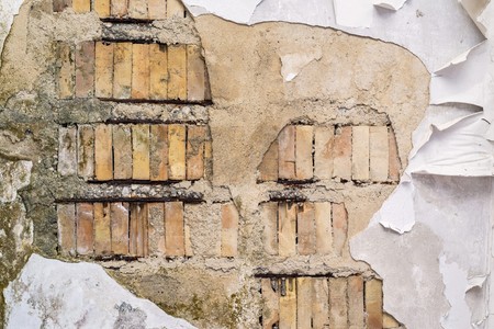 old brick wall or ceiling with the destroyed and fragmentary plasterの写真素材