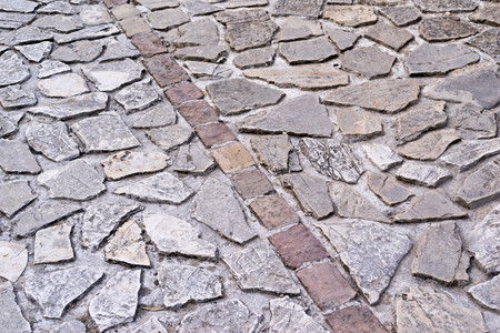 abstract texture of an old stone pavement or the sidewalk for a vintage backgroundの写真素材
