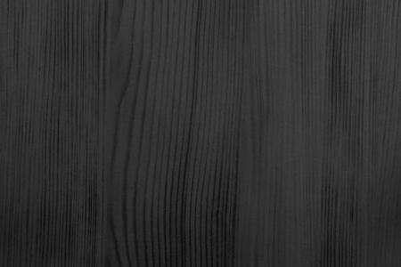 wood texture of a longitudinal section with streaks or with fibers for abstract background of black colorの写真素材