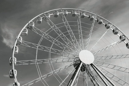 metal design a ferris wheel or an attraction with cabins for a panoramic review against the sky of...