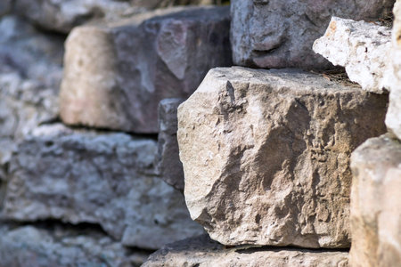 big piece of a stone closeup on an indistinct background from other stones