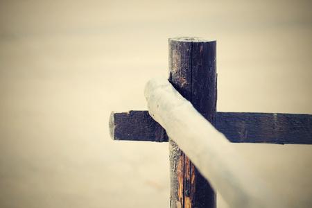 fragment of an old column and poles from a wooden fence for the ranch closeup on an indistinct background in retro styleの写真素材