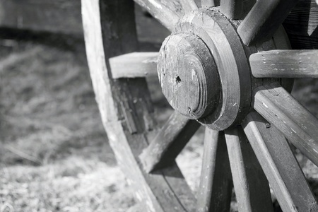 of gray color fragment of a big wooden wheel with spokes for an ancient cartage and for the cart or the vehicleの写真素材
