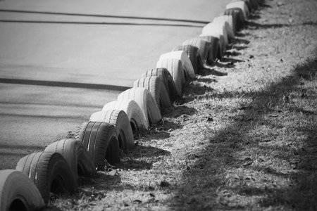 attraction in an amusement park the autodrome for a auto buggy with a buffer protection from old auto tiresの写真素材