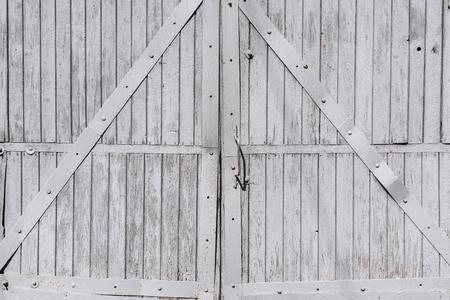 old wooden gate of gray color closeup in retro style for a backgroundの写真素材