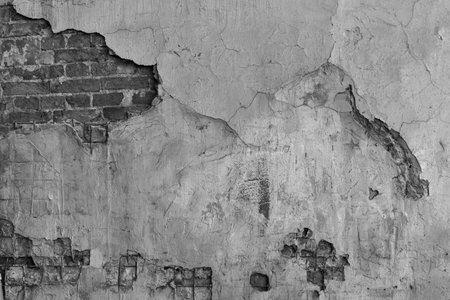 the old textured brick wall with the destroyed plaster for an abstract background or for wallpaper of monochrome toneの写真素材