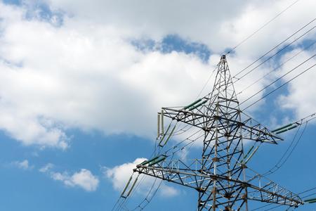high-voltage support of electricity transmissions or iron mast closeup against the cloudy sky and a blank space for the textの写真素材