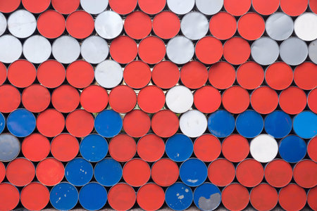 the textured abstract background from the round bottoms of old iron barrels of red blue white color