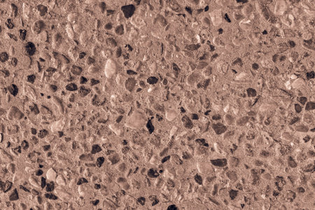 rough abstract surface of a floor or the sidewalk from stone pebble of brown color for the grained...