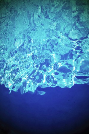 flickering background and abstract texture of brilliant water of bright blue green colorの写真素材