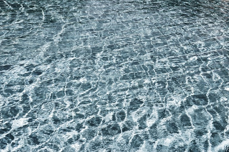 flickering background and abstract texture of brilliant water of bright silvery green color