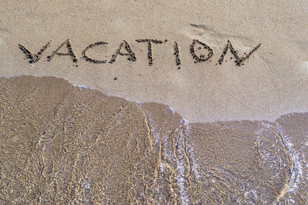 vacation an inscription closeup on wet sand of the sea coast