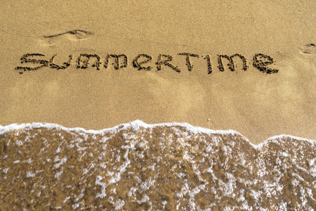 summertime an inscription closeup on wet sand of the sea coast