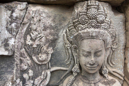 the image or historical engraving on a stone wall of the temple in Cambodia is more ancient artの写真素材