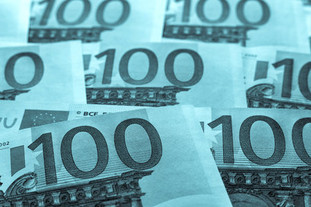 abstract unsharp background a collage from money and currency or from paper banknotes in hundred euros closeup of tinted colorの写真素材