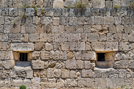 old stone wall of ancient fortress for a background with vintage textureの写真素材