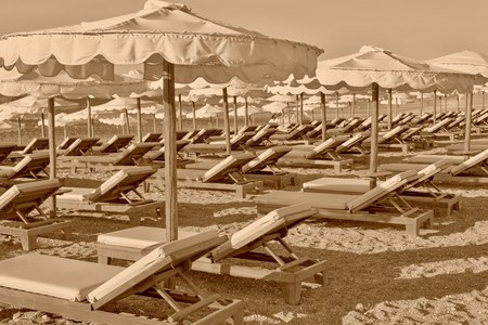 beach sunbeds and sunshades closeup of sepia toneの写真素材
