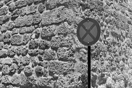 one street sign the stop is forbidden by a closeup against the background of an old stone wall of monochrome toneの写真素材