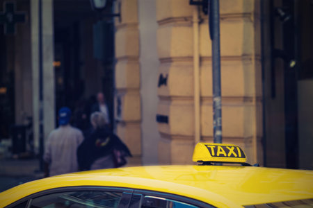 fragment of one yellow car of the taxi with the sign or with a symbol closeup and in the color photo in retro styleの写真素材