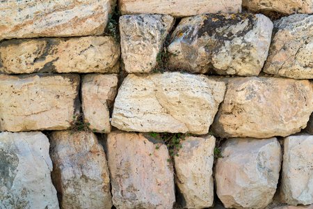 the textured surface of an ancient stone wall for backgrounds and for wallpaperの写真素材