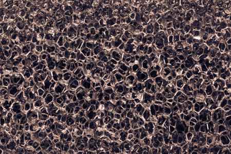 Background and abstract twisted or tangled mesh texture of synthetic material closeup glamorous gray colorの写真素材