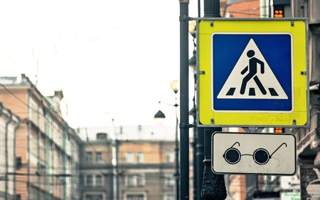 the street sign or the road sign the crosswalk and transition for blind people on the city streetの写真素材