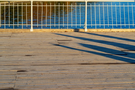 part or fragment of an iron handrail of the bridge with a wooden scaffold