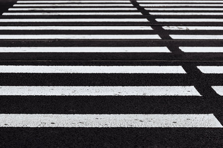 road marking of the crosswalk on asphalt closeup for a background