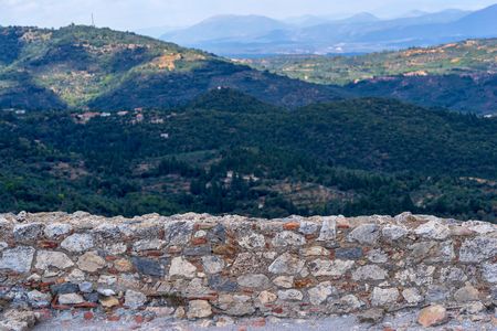 old and ancient stone wall closeup on an indistinct background of a natural landscapeの写真素材