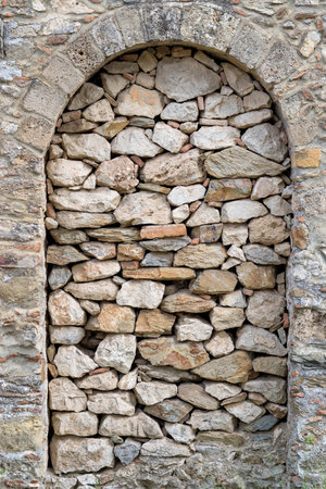 ancient stone and old wall with an arch in a niche closeup for a background or for wallpaper