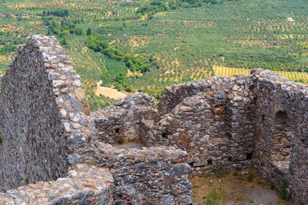 the destroyed and old ancient stone ruins closeup on an indistinct landscape backgroundの写真素材