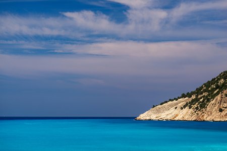 sea and sky landscape with the horizon and a separate side ledge of the mountain or hillの写真素材