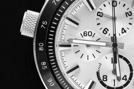 a half of a part of the men's watch of chronographs closeup in black white tone