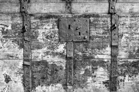 Vintage texture of an old wooden surface with rusty metal on a chest closeup for background or for wallpaper with monochrome tone.の写真素材