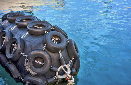 abstract a large rubber bump stop on the water for the mooring of a marine vesselの写真素材