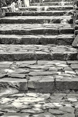 old ancient staircase with stone steps outdoors closeup for an abstract background