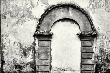 imitation an abstract ancient shape of the arch on an old plastered wall closeup for a vintage frame or for a background of monochrome toneの写真素材