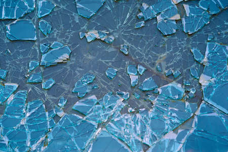 abstract texture of broken and cracked car glass close-up for background or for wallpaper of blue colorの写真素材