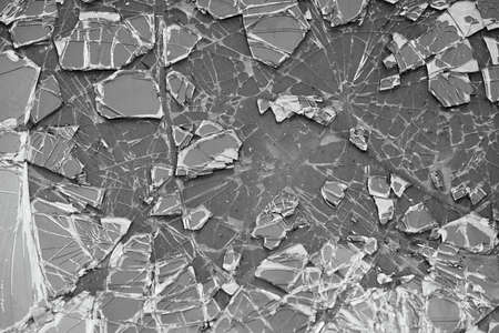 abstract texture of broken and cracked car glass close-up for background or for wallpaper of monochrome toneの写真素材