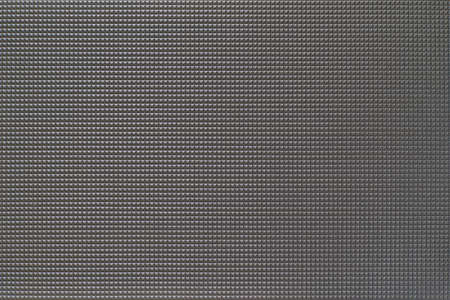 granular corrugated texture with small convex pyramids or teeth of regular square shape for background or for wallpaperの写真素材